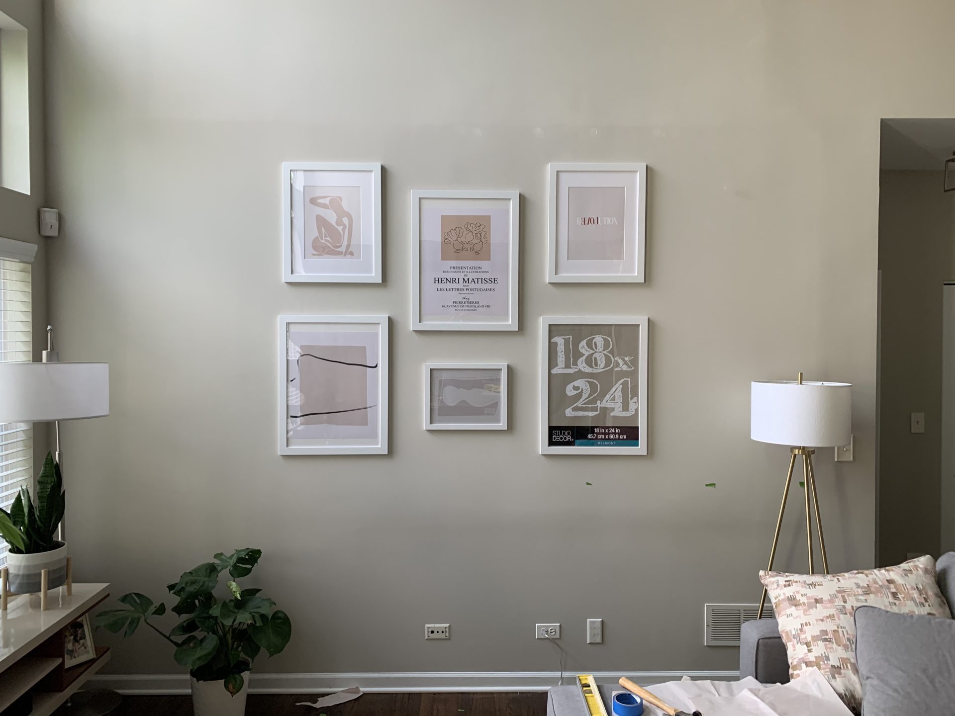 Mounting by a local handyman, six Henri Matisse works of art in white frames hang on a wall