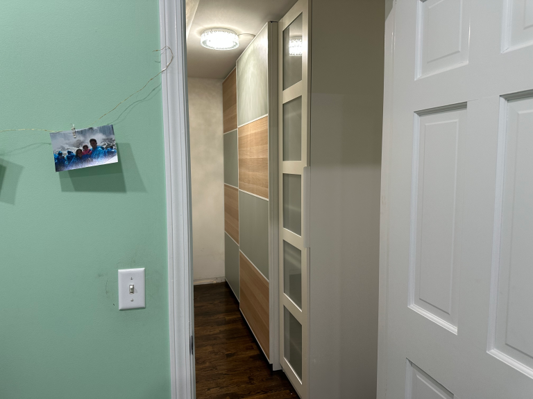 PAX wardrobe assembly with sliding doors in walk-in closet